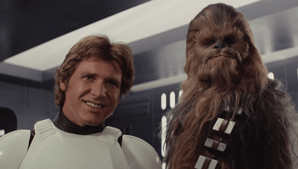 Harrison Ford e Peter Mayhew in una scena del film Star Wars: Una nuova speranza (1977) diretto da George Lucas